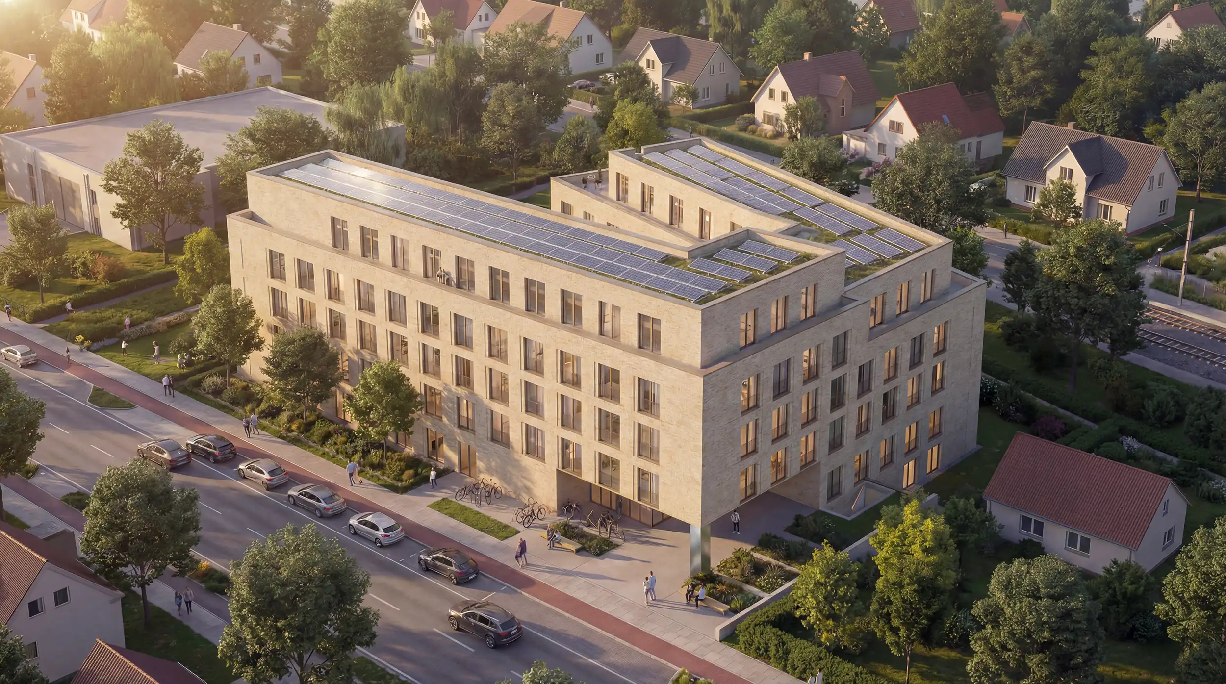 Luftbild des hellen Klinkerbaus mit Solardach an der Straße zwischen Einfamilienhäusern